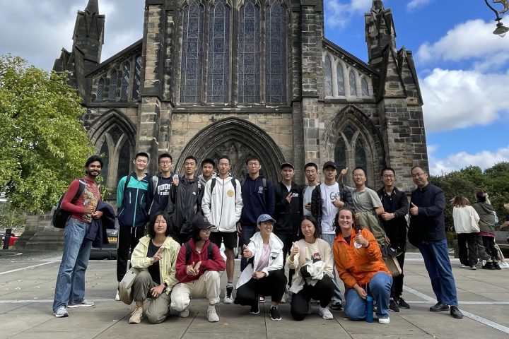a group of people walking in front of a church