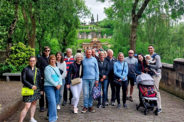 a group of people standing next to a tree
