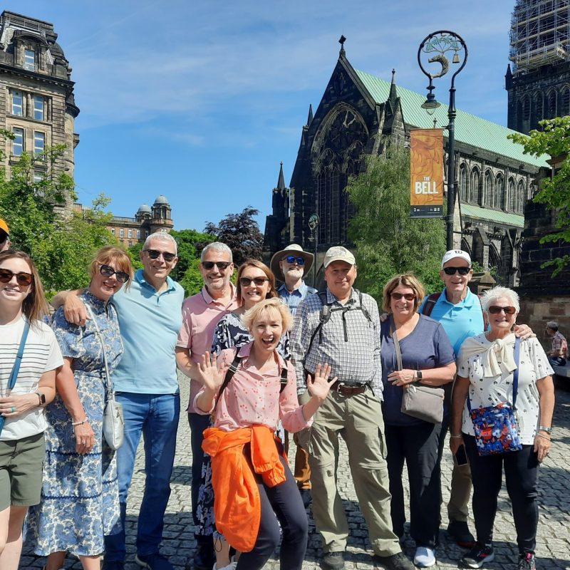 a group of people standing in front of a crowd posing for the camera