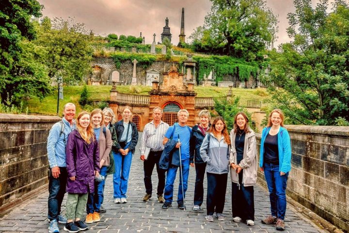 a group of people standing on a sidewalk
