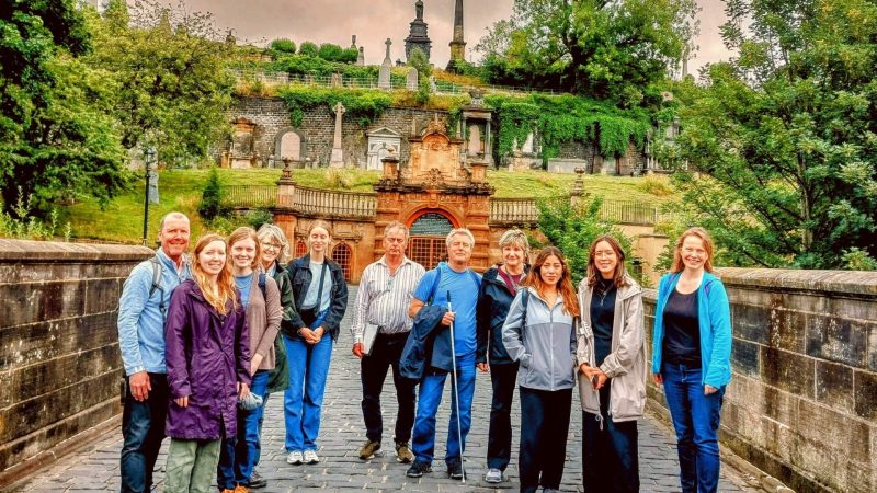 a group of people standing on a sidewalk