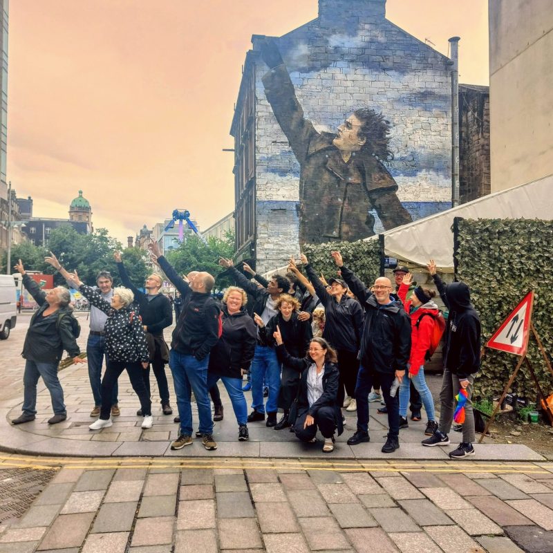 a group of people standing in front of a brick building