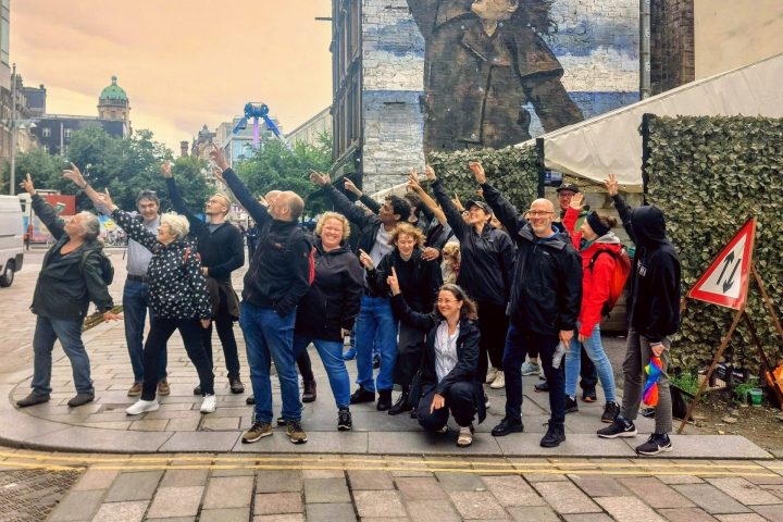 a group of people standing in front of a brick building