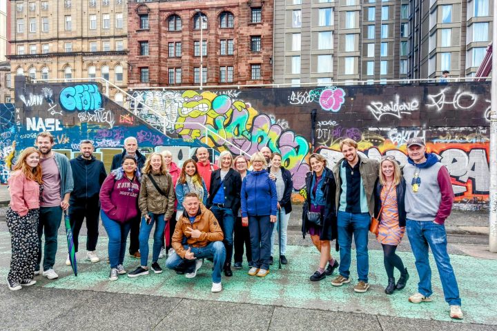 a group of people standing in front of a crowd posing for the camera