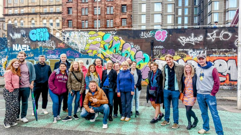 a group of people standing in front of a crowd posing for the camera