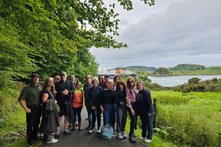 a group of people standing next to a tree