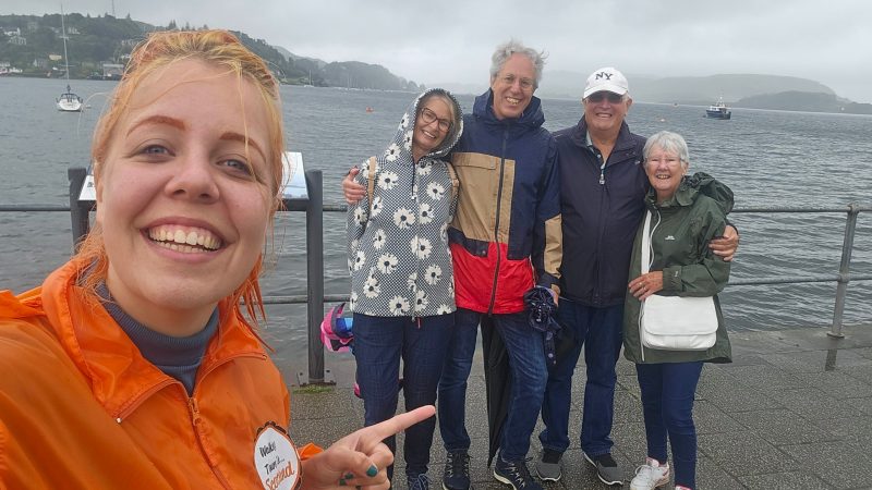 a group of people standing in a body of water posing for the camera