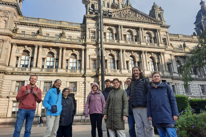 a group of people walking in front of a building