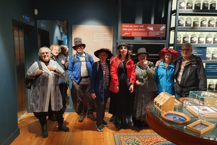a group of people standing around a table