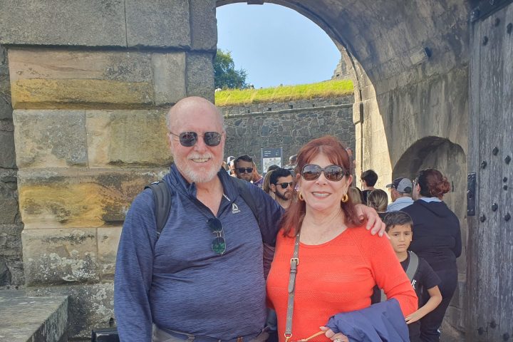 a man and a woman standing in front of a building