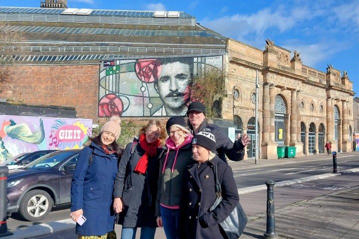 a group of people standing in front of a building
