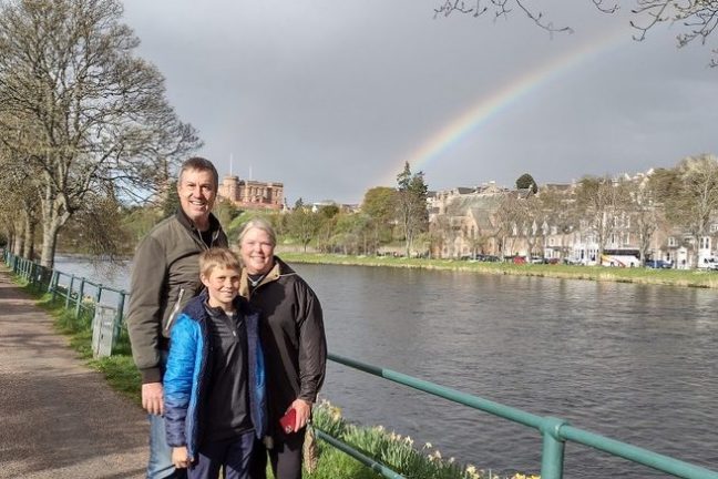 a man and a woman standing in a park