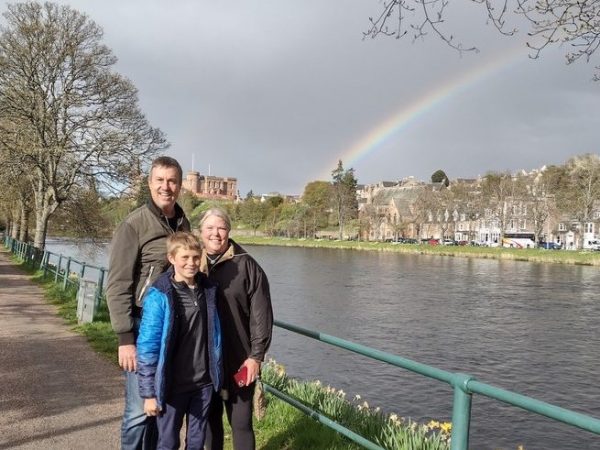 a man and a woman standing in a park