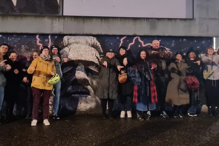 a group of people standing in front of a crowd posing for the camera