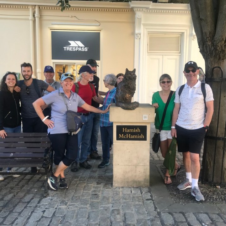 a group of people standing in front of a building