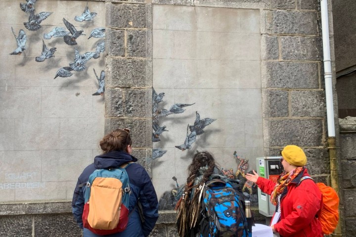 a group of people standing in front of a building