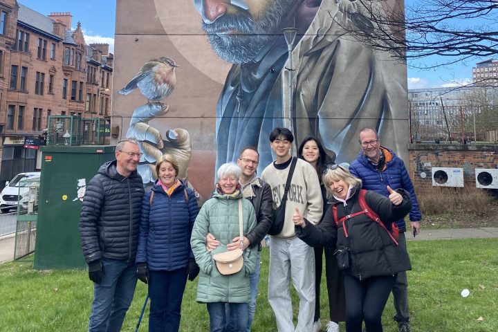 a group of people standing in front of a statue