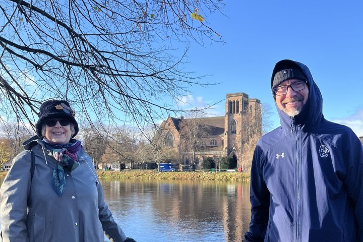 a person standing next to a body of water