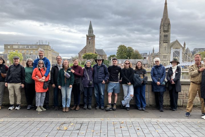 a group of people standing in front of a crowd posing for the camera