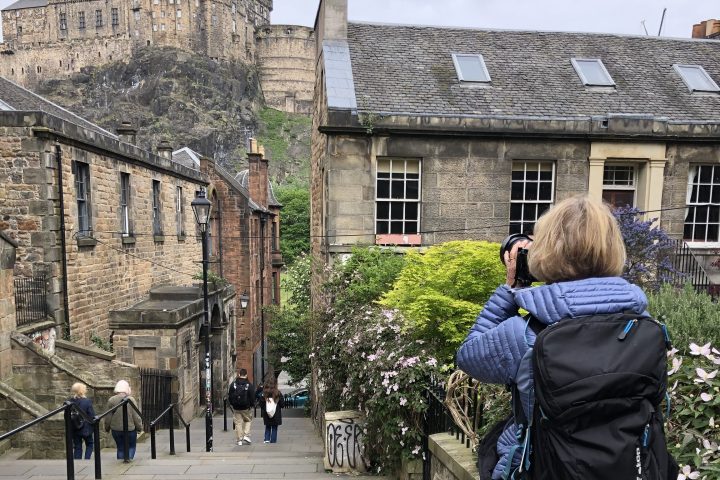 a group of people walking down a street next to a building