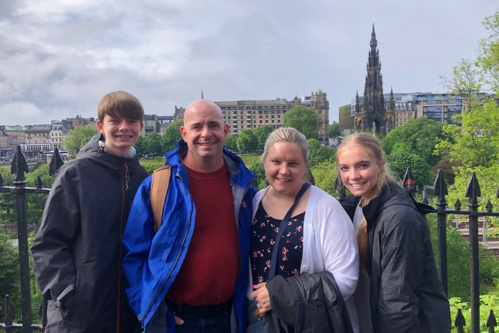 a man standing in front of a group of people posing for the camera