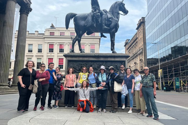 a group of people standing in front of a statue
