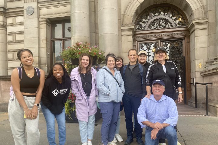 a group of people standing in front of a building