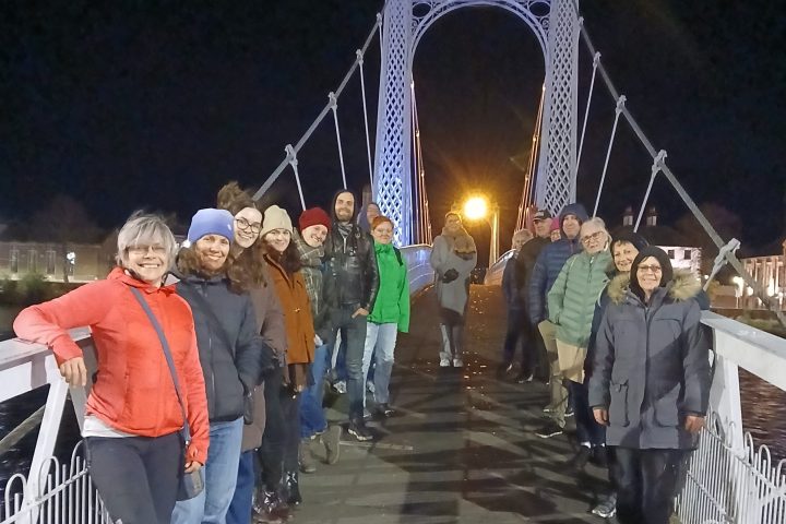 a group of people walking on a bridge