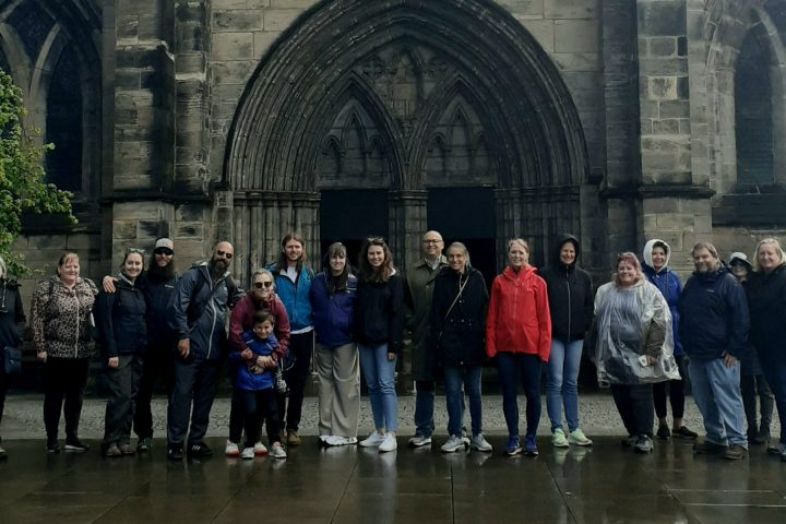 a group of people walking in front of a church