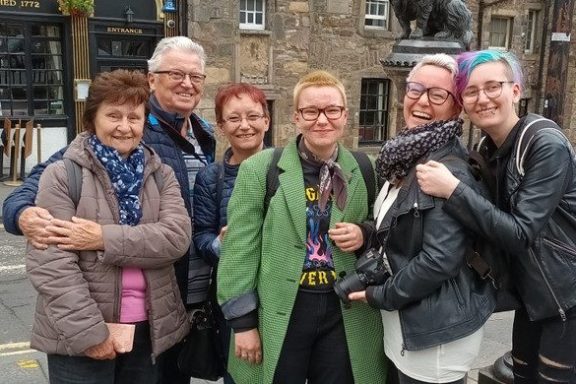 a group of people standing on a sidewalk
