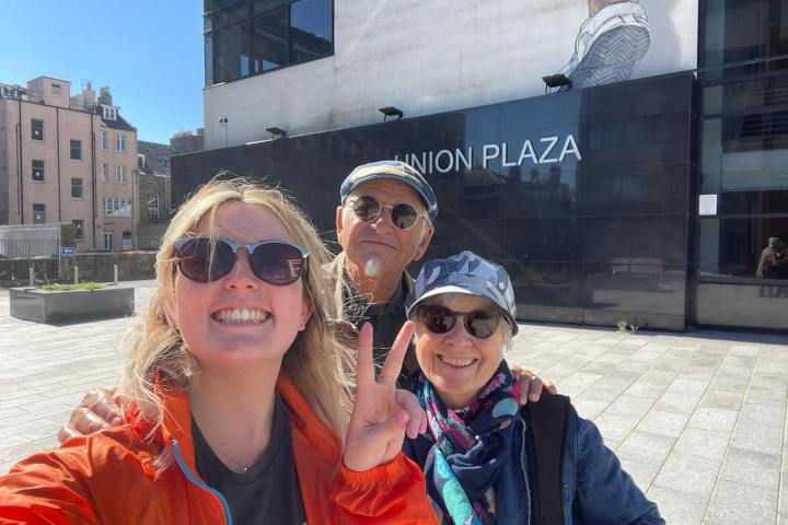 a person wearing sunglasses in front of a building