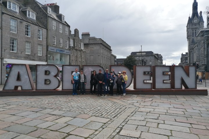 a clock tower in front of a brick building