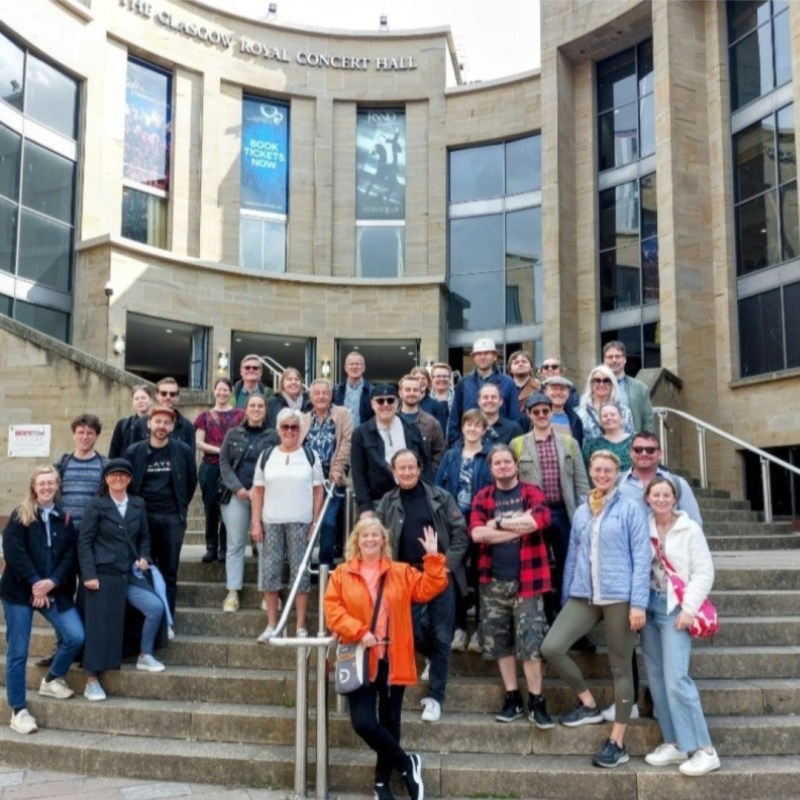 a group of people walking in front of a building