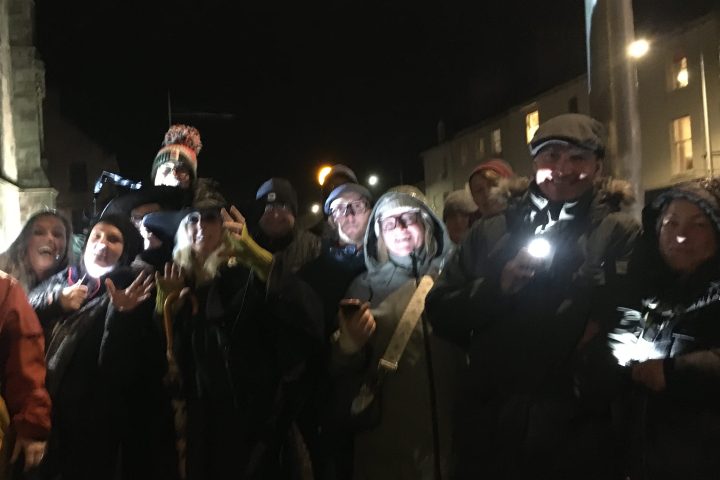 a group of people standing in front of a crowd posing for the camera