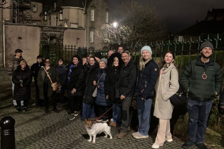 a group of people standing in front of a crowd posing for the camera