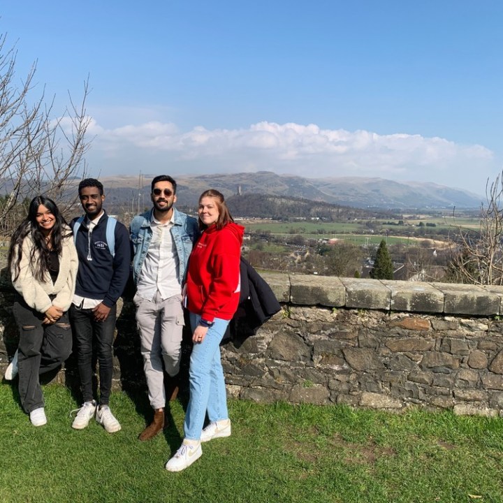 a group of people standing in a field