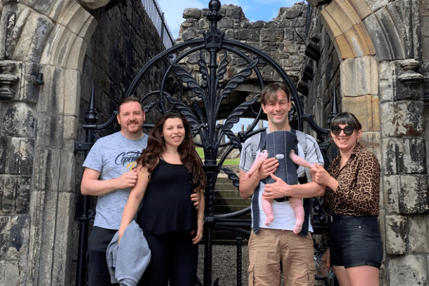 a couple of people that are standing in front of a brick building