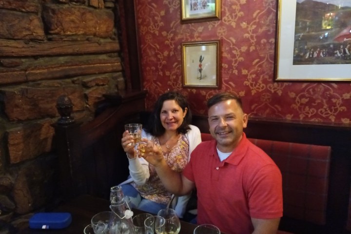 a man and a woman sitting at a table with wine glasses