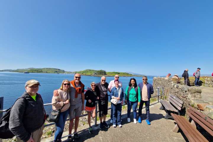 a group of people on a beach posing for the camera