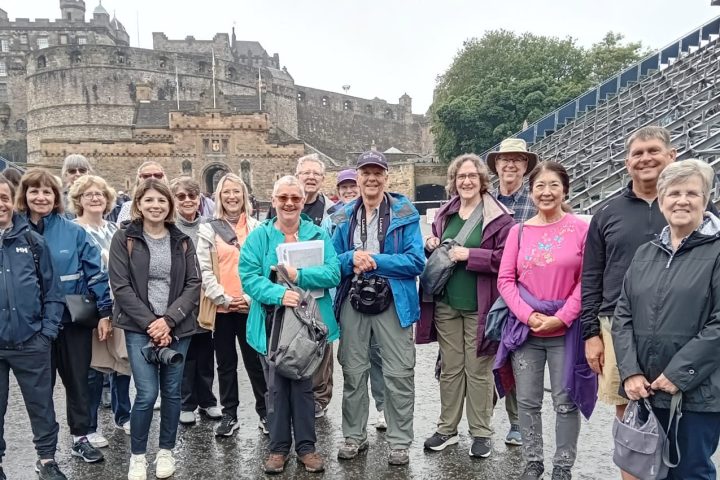 a group of people standing in front of a crowd posing for the camera