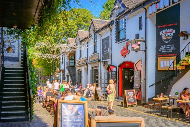 a group of people walking in front of a building