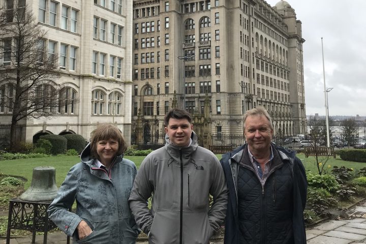 a group of people standing in front of a building