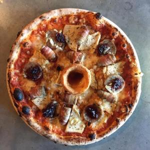 a pizza sitting on top of a pan