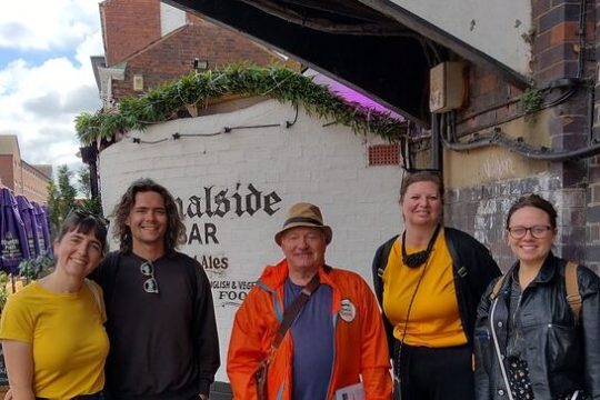 a group of people posing for a photo in front of a building
