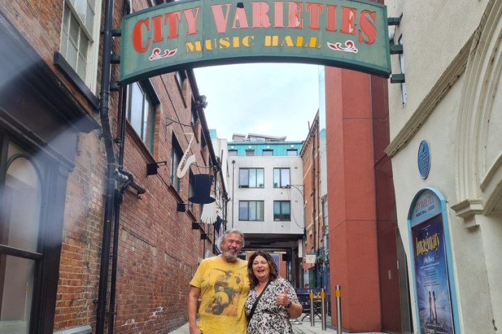 a person walking down a sidewalk in front of a building