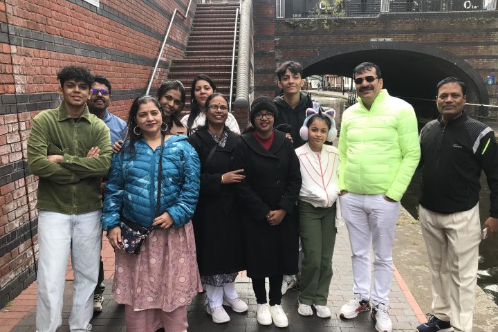 a group of people standing in front of a crowd posing for the camera