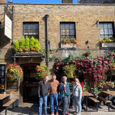 a group of people standing in front of a brick building