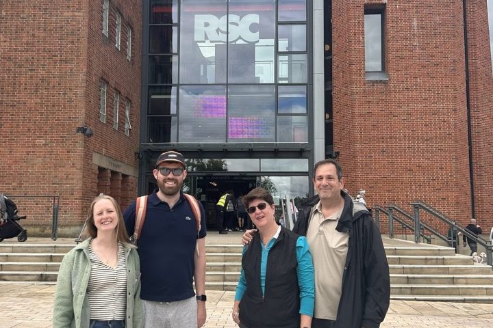 a group of people standing in front of a brick building