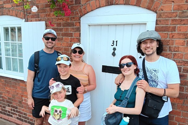 a group of people standing in front of a brick building