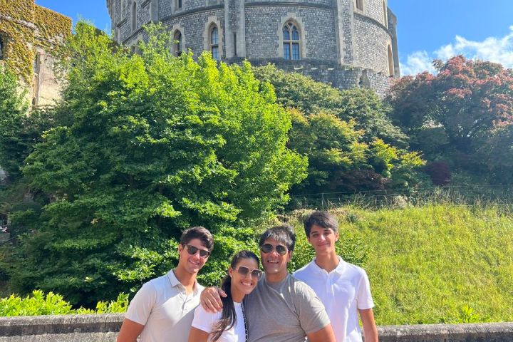 a group of people standing in front of a stone building